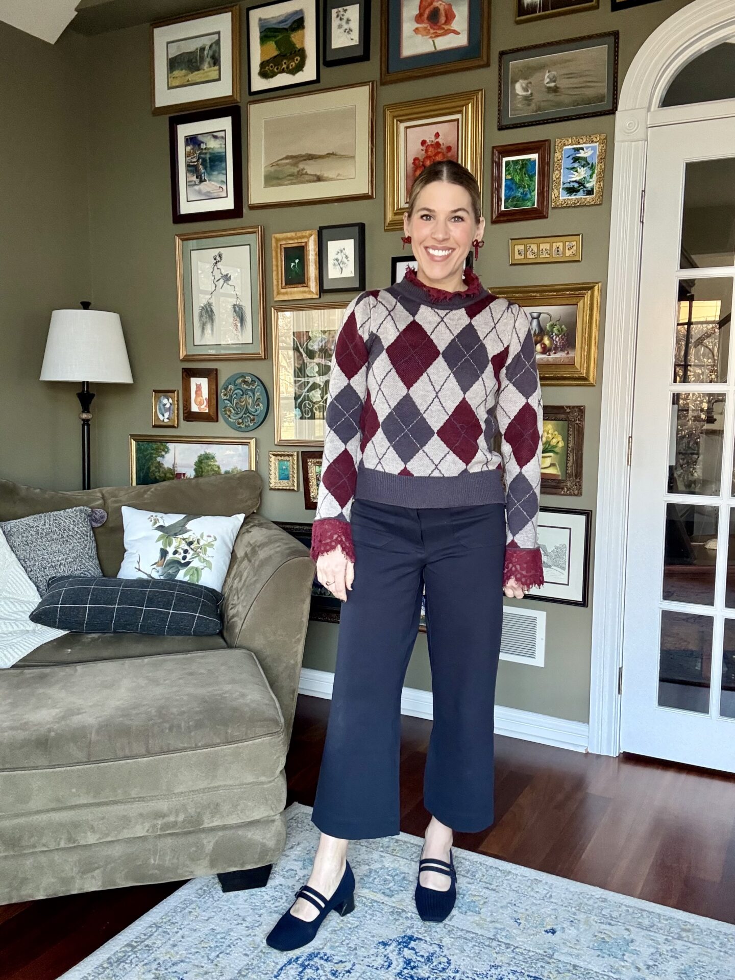 Argyle sweater with lace collar and cuffs styled with navy trousers for work.